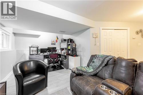 Finished basement featuring wood-finish flooring, a functional window, and a built-in closet with bi-fold doors - 185 Highland Crescent Unit# 2, Kitchener, ON - Indoor