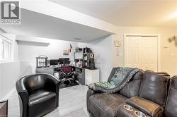Finished basement featuring wood-finish flooring, a functional window, and a built-in closet with bi-fold doors - 
