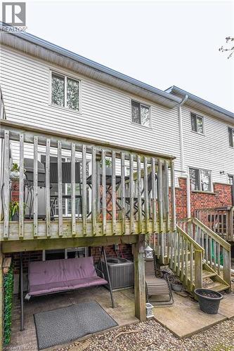 Multi-level deck and patio area featuring wooden railing and steps - 185 Highland Crescent Unit# 2, Kitchener, ON - Outdoor With Deck Patio Veranda