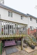 Multi-level deck and patio area featuring wooden railing and steps - 