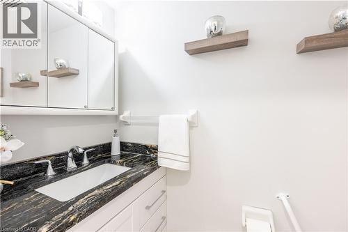 Bathroom vanity with a dark patterned countertop, integrated rectangular sink, and chrome faucet - 185 Highland Crescent Unit# 2, Kitchener, ON - Indoor Photo Showing Bathroom