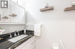 Bathroom vanity with a dark patterned countertop, integrated rectangular sink, and chrome faucet - 