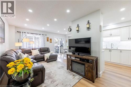 Open concept living area featuring recessed lighting, light wood-finish flooring, and a sliding glass door - 185 Highland Crescent Unit# 2, Kitchener, ON - Indoor Photo Showing Living Room