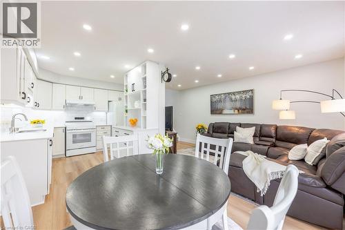 Open-concept living space featuring a kitchen with white cabinetry, white subway tile backsplash, and recessed lighting - 185 Highland Crescent Unit# 2, Kitchener, ON - Indoor