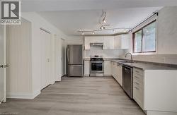 Clothes closet and pantry to left of fridge. - 