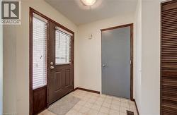 Tiled foyer and inside entry to garage. - 