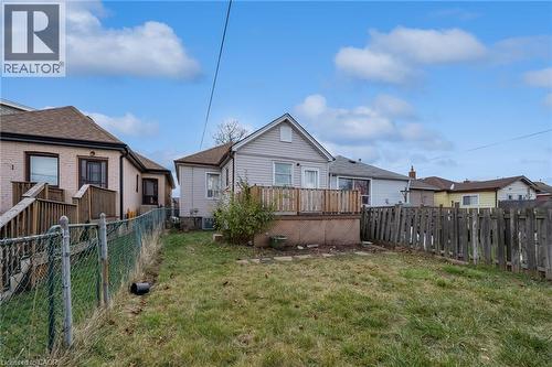 Rear exterior with light-colored siding and a wooden deck - 29 Harrison Avenue, Hamilton, ON - Outdoor With Deck Patio Veranda