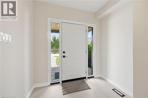 Entryway featuring a modern paneled door with sidelights, providing natural illumination - 5628 Stella Lane, Burlington, ON - Indoor Photo Showing Other Room