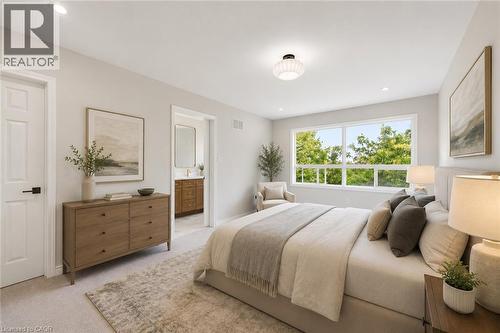 Spacious bedroom with light-toned carpeting and a large window overlooking lush greenery - 5628 Stella Lane, Burlington, ON - Indoor Photo Showing Bedroom