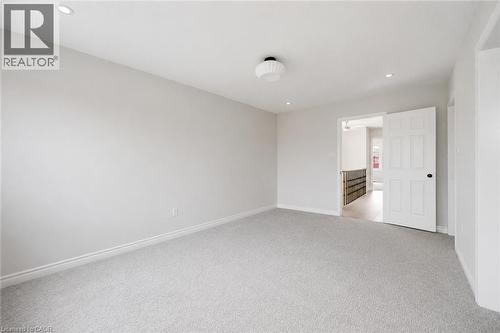 Spacious room featuring light gray carpeting and neutral wall paint - 5628 Stella Lane, Burlington, ON - Indoor Photo Showing Other Room