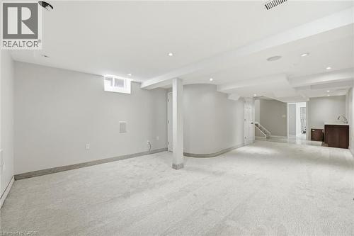 Spacious finished basement featuring light gray carpeting, recessed lighting, and a neutral color palette - 5628 Stella Lane, Burlington, ON - Indoor Photo Showing Basement