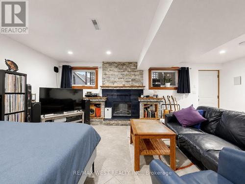 Fireplace with B/I Shelves, Above Grade Windows - 335 East Avenue N, Hamilton, ON - Indoor Photo Showing Living Room With Fireplace
