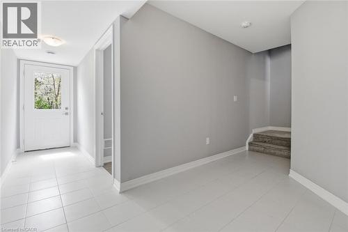 Entryway featuring light-toned tile flooring, a white glass-paned door, and painted trim - 5 Hagar Street, Thorold, ON - Indoor Photo Showing Other Room