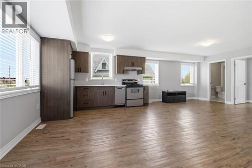 Open-concept living area with wood-finish flooring, recessed lighting, and multiple windows with blinds - 5 Hagar Street, Thorold, ON - Indoor Photo Showing Kitchen