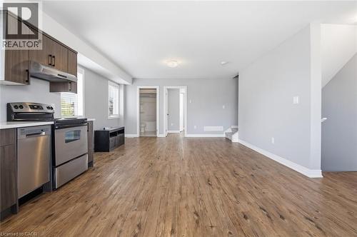 Open-concept living area featuring wood-finish flooring, light gray walls, and white trim - 5 Hagar Street, Thorold, ON - Indoor Photo Showing Kitchen