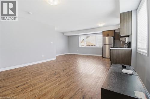 Open-concept living space featuring wood-finish flooring, light gray wall tones, and recessed lighting - 5 Hagar Street, Thorold, ON - Indoor Photo Showing Other Room