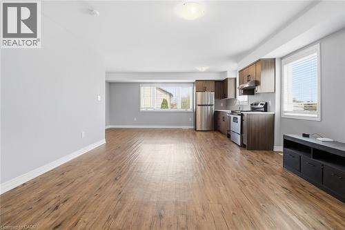 Open-concept living space featuring wood-finish flooring, light grey walls, and white trim - 5 Hagar Street, Thorold, ON - Indoor Photo Showing Kitchen