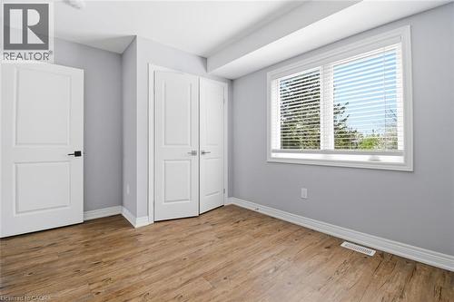 Room featuring wood-finish flooring, light grey walls, and white trim - 5 Hagar Street, Thorold, ON - Indoor Photo Showing Other Room