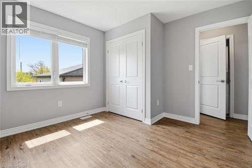 Room featuring wood-finish flooring, light gray wall paint, and white baseboards - 5 Hagar Street, Thorold, ON - Indoor Photo Showing Other Room