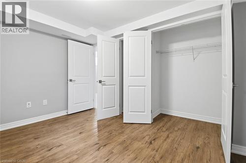 Room featuring wood-finish flooring, light gray walls, and white baseboards - 5 Hagar Street, Thorold, ON - Indoor Photo Showing Other Room