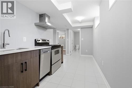 Kitchenette featuring stainless steel appliances, wood-finish cabinetry, white countertop, and tiled flooring - 5 Hagar Street, Thorold, ON - Indoor Photo Showing Kitchen