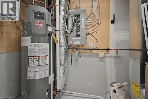 Utility area featuring a water heater, electrical panel, ductwork, and exposed piping - 5 Hagar Street, Thorold, ON - Indoor Photo Showing Basement