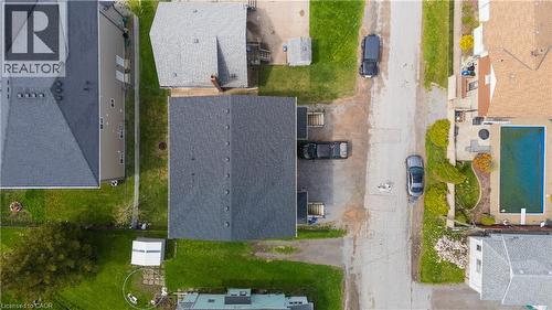 Property featuring a dark shingle roof, green lawn, and a paved driveway - 5 Hagar Street, Thorold, ON - Outdoor With View