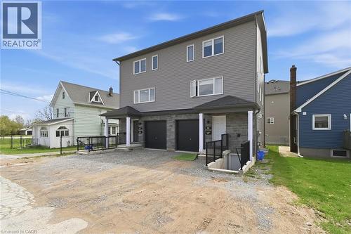 Contemporary multi-unit dwelling featuring a gray siding facade and stone accents - 5 Hagar Street, Thorold, ON - Outdoor
