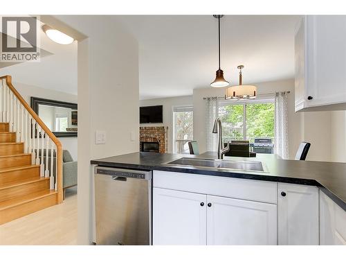 Kitchen to dining and living room - 133 Wyndham Crescent Unit# 110, Kelowna, BC - Indoor Photo Showing Kitchen With Double Sink