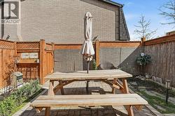 Outdoor patio featuring interlocking pavers and a dedicated garden bed - 