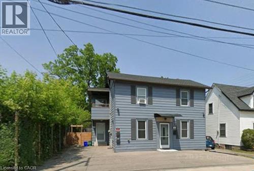 Two-story residence featuring blue siding, dark shutters, and a dark shingle roof - 773 Lawrence Road, Hamilton, ON - Outdoor