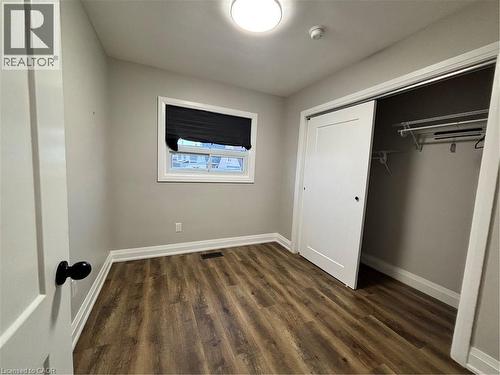 Interior room featuring wood-finish flooring, light grey walls, and white trim - 773 Lawrence Road, Hamilton, ON - Indoor Photo Showing Other Room