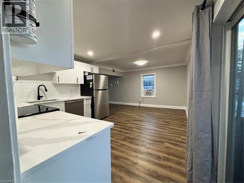 Contemporary kitchen featuring white cabinetry, quartz countertops, a subway tile backsplash, and stainless steel appliances - 773 Lawrence Road, Hamilton, ON - Indoor