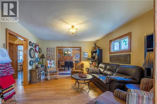 Open living space featuring wood-finish flooring, warm wall tones, and recessed lighting - 5 Hawthorne Avenue, Simcoe, ON - Indoor Photo Showing Living Room