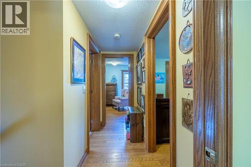 Hallway featuring wood-finish flooring and multiple doorways with wood trim - 5 Hawthorne Avenue, Simcoe, ON - Indoor Photo Showing Other Room