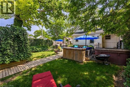 Expansive backyard featuring a manicured lawn and mature trees - 5 Hawthorne Avenue, Simcoe, ON - Outdoor With Backyard