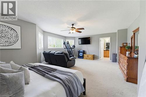 Spacious room featuring light gray walls, light-colored carpeting, multiple windows with white blinds, and a ceiling fan with integrated lighting - 29 Watson Crescent, Ayr, ON - Indoor Photo Showing Bedroom