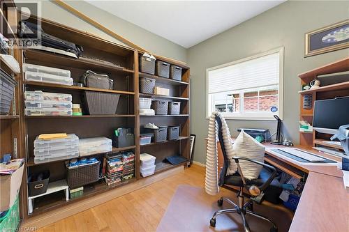 Built-in shelving units, wood-finish flooring, a window with blinds, and a built-in desk with overhead shelving - 29 Watson Crescent, Ayr, ON - Indoor Photo Showing Office