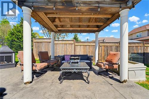 Stamped concrete patio featuring a wood pergola with decorative pillars, built-in string lighting, and a privacy fence - 29 Watson Crescent, Ayr, ON - Outdoor With Deck Patio Veranda