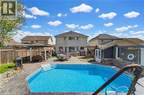 Expansive backyard featuring an in-ground swimming pool, stamped concrete patio, and a dedicated covered gazebo - 29 Watson Crescent, Ayr, ON - Outdoor With In Ground Pool With Deck Patio Veranda With Backyard