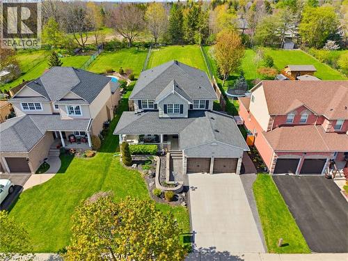 Modern colonial-style home featuring a prominent two-car garage, expansive driveway, and a covered front porch with columns - 29 Watson Crescent, Ayr, ON - Outdoor