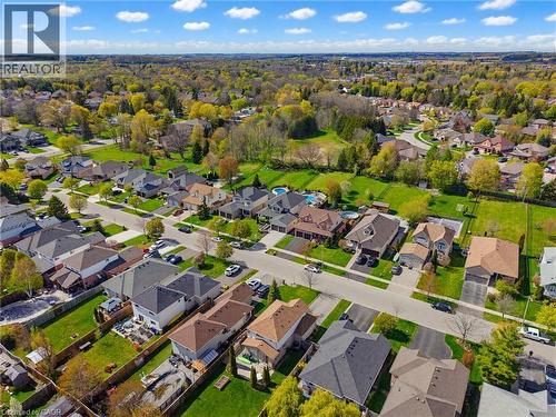 Aerial perspective showcasing a residential neighborhood with varied architectural styles and mature trees - 29 Watson Crescent, Ayr, ON - Outdoor With View