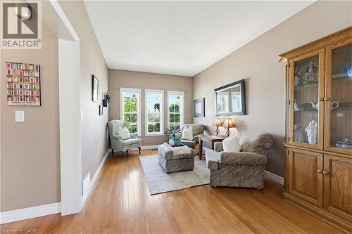 Spacious interior room featuring warm wood-finish flooring, a vaulted ceiling, and neutral-toned walls - 29 Watson Crescent, Ayr, ON - Indoor Photo Showing Living Room