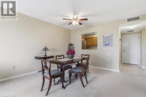 Dining area with light-toned carpeting and neutral wall tones - 10 Ellen Street E Unit# 808, Kitchener, ON - Indoor Photo Showing Dining Room