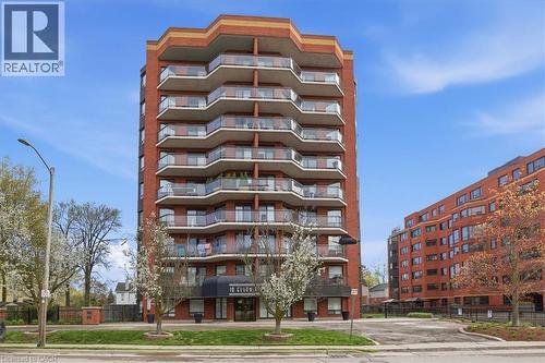 Red brick high-rise building featuring a multi-story design with stacked balconies - 10 Ellen Street E Unit# 808, Kitchener, ON - Outdoor With Facade