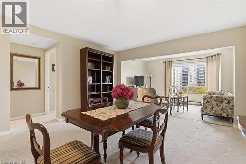 Open-concept living area with neutral wall tones and light-colored carpeting throughout - 10 Ellen Street E Unit# 808, Kitchener, ON - Indoor Photo Showing Dining Room