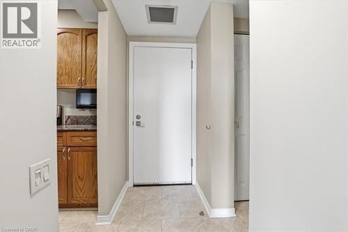Entryway featuring light-toned tile flooring and a white entry door - 10 Ellen Street E Unit# 808, Kitchener, ON - Indoor Photo Showing Other Room
