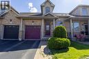 Brick facade with covered entry and a purple front door - 4066 Medland Drive, Burlington, ON  - Outdoor With Facade 