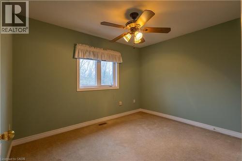 Bedroom featuring a ceiling fan with integrated lighting, a double-hung window, and wall-to-wall carpeting - 4066 Medland Drive, Burlington, ON - Indoor Photo Showing Other Room