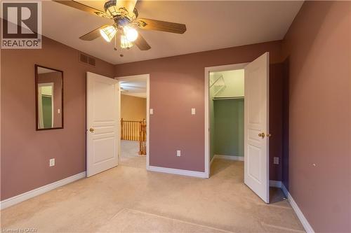 Carpeted room with a ceiling fan light fixture - 4066 Medland Drive, Burlington, ON - Indoor Photo Showing Other Room